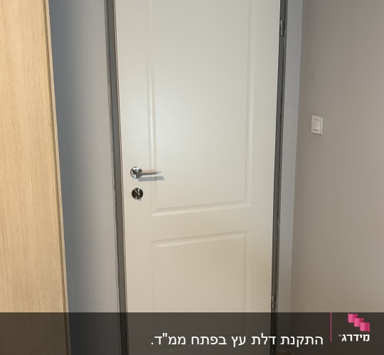 דלת לבנה מותקנת בחדר עם רצפת קרמיקה